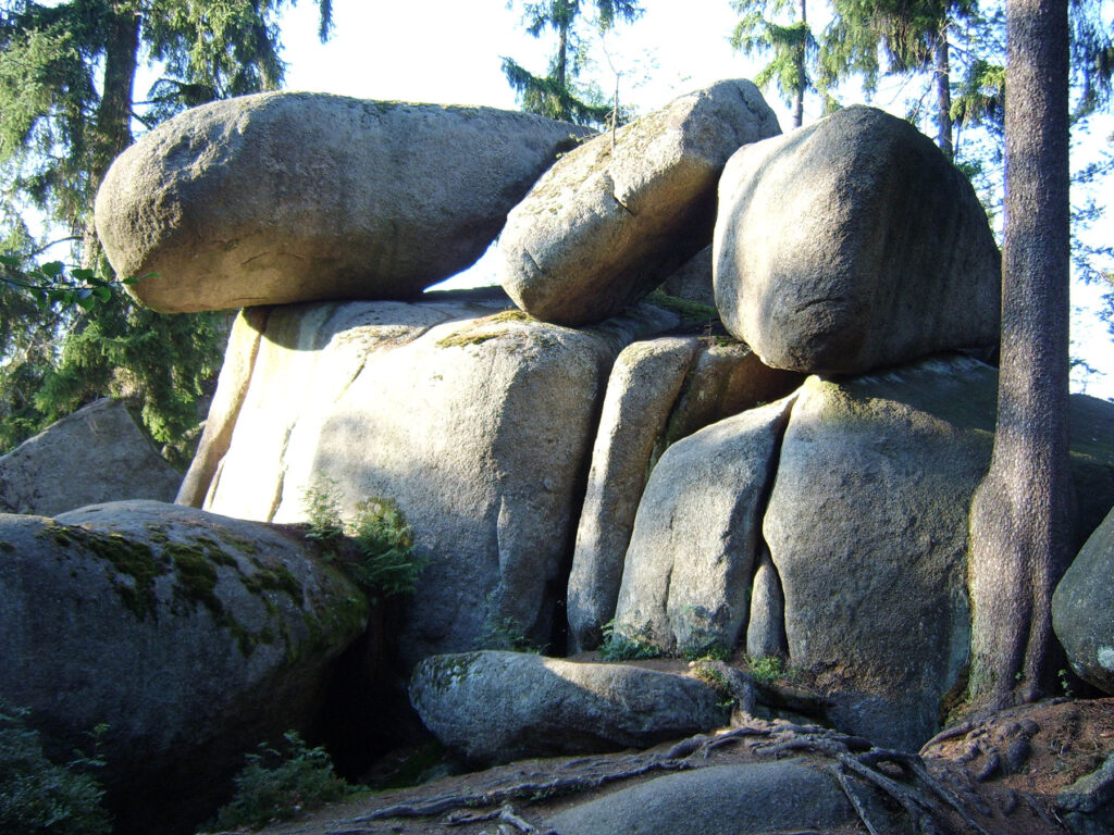 Felsenlabyrinth nahe Wunsiedel im Fichtelgebirge: Große graue Granitblöcke türmen sich im Wald, umgeben von Bäumen, Moos und weiteren Felsformationen.